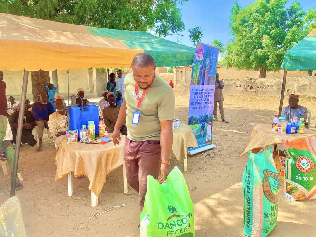 LHI staff registering beneficiaries at a community distribution point
