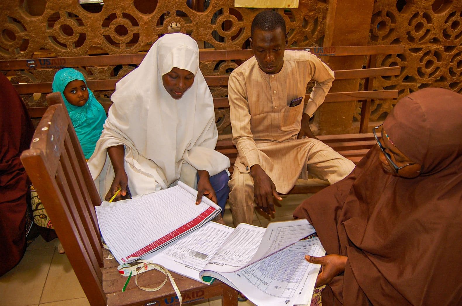 Health workers reviewing patient records during mentoring