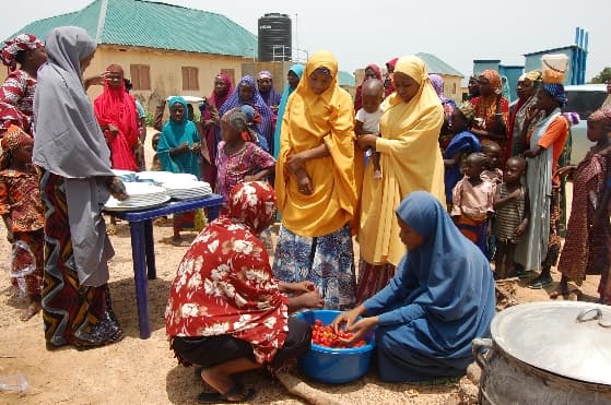Women preparing local foods at an LHI nutrition awareness session